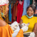 Young,African,Business,Woman,Collecting,Money,From,A,Customer